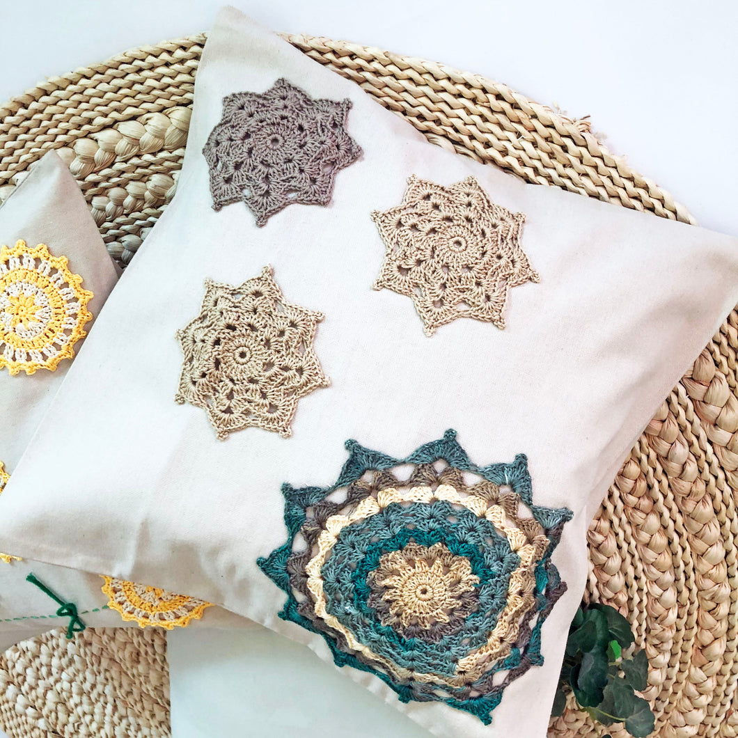 Crochet Harmony: Beige Cushion with Earthy Mandalas and a Pop of Teal for a Bohemian Touch