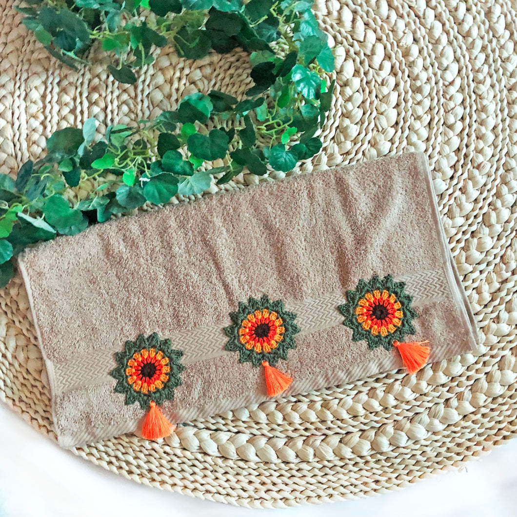 Vibrant Blooms: Beige Towel featuring Handmade Crochet Flowers in Olive Green and Orange.